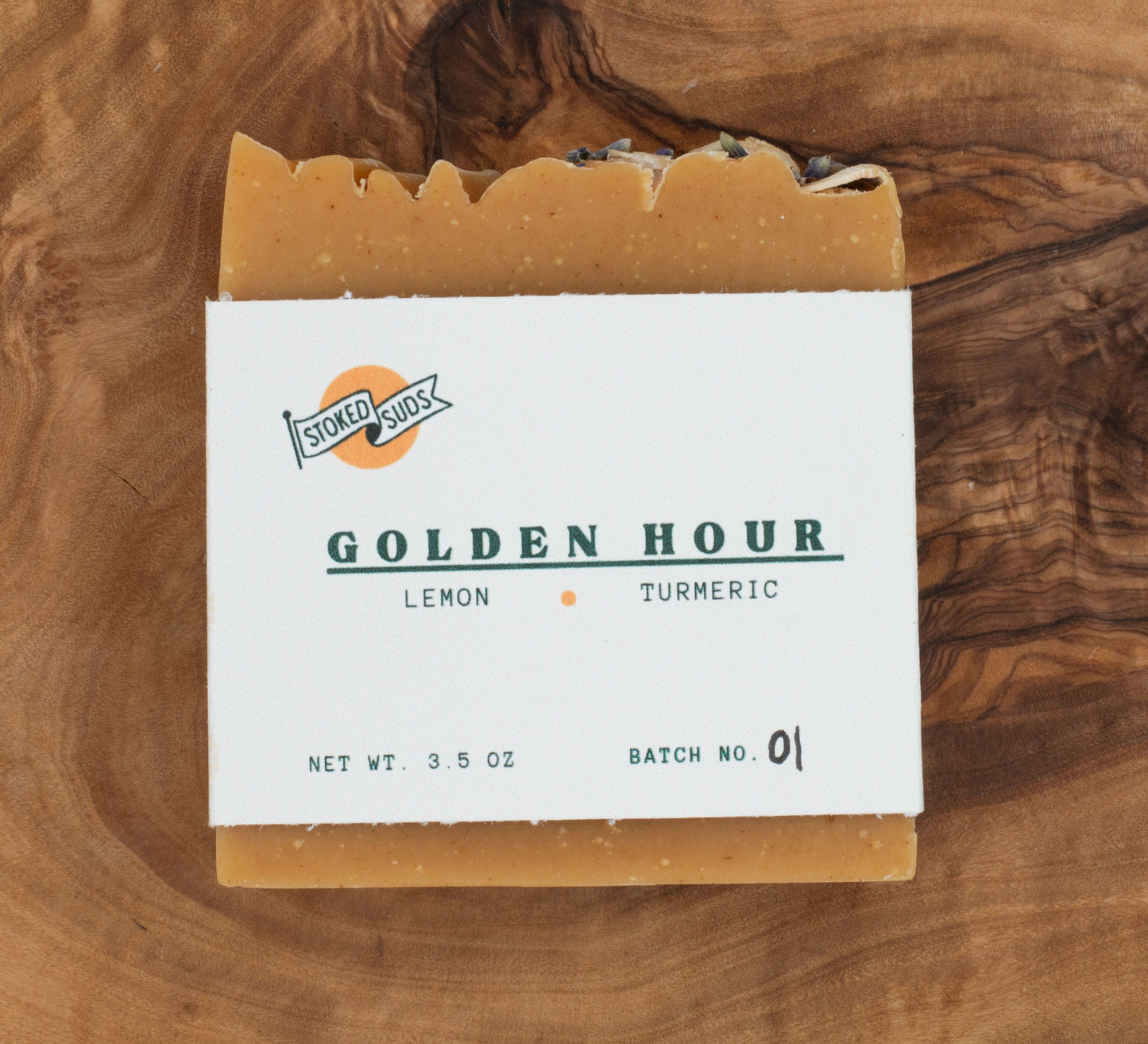 Bar of soap with a label on a wooden surface