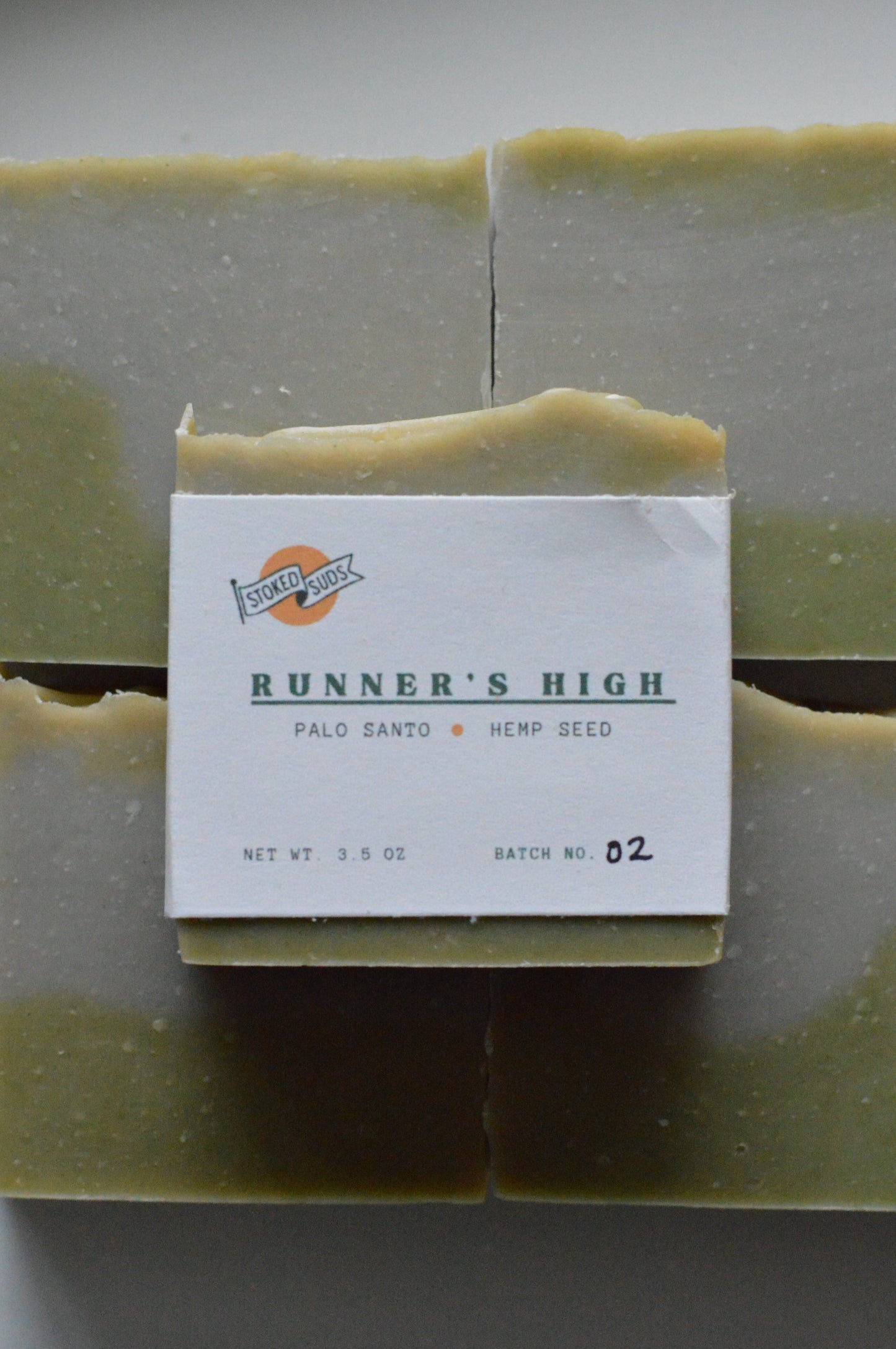 Green soap bar with a label on a gray background