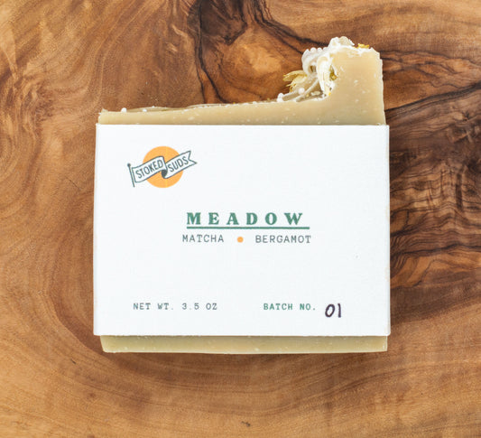 Bar of soap with a label on a wooden surface